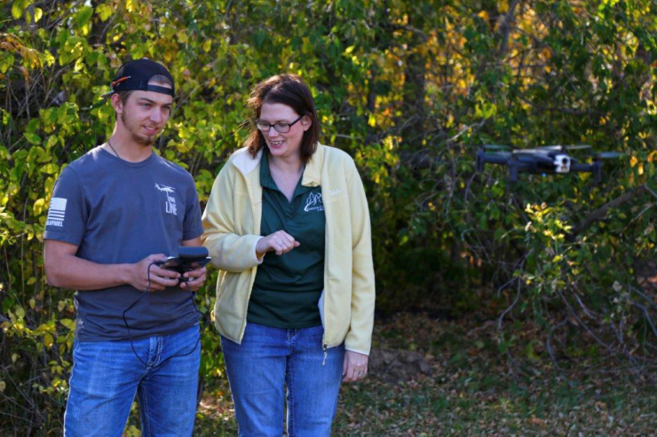 Faculty & student flying a drone